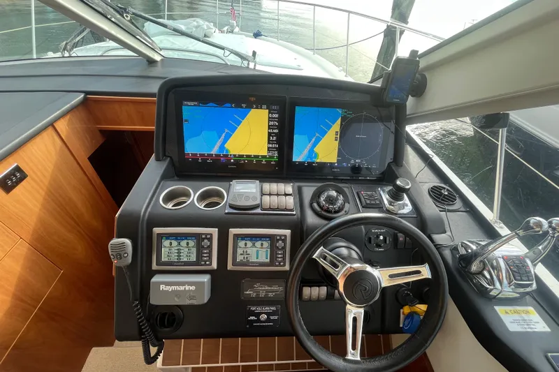  Yacht Photos Pics Helm of 2015 Riviera 5000 Sport Yacht with navigation screens and controls.