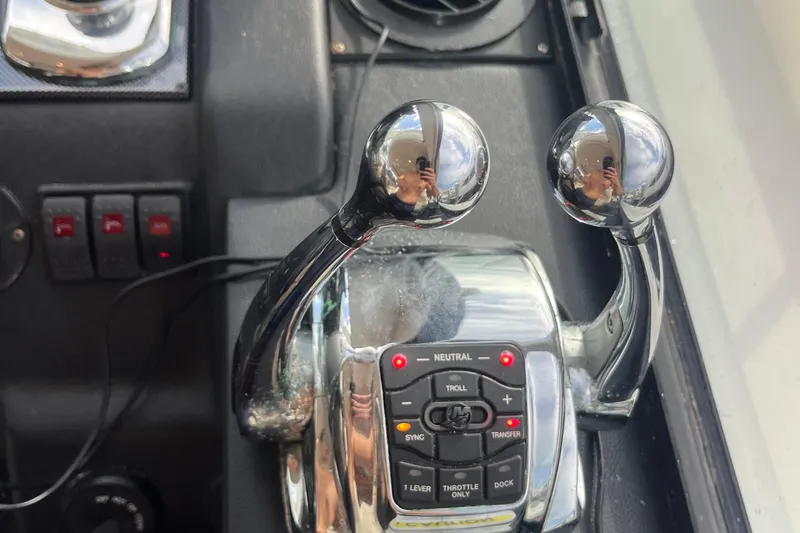  Yacht Photos Pics Control levers of a 2015 Riviera 5000 Sport Yacht cockpit, featuring chrome finish and control buttons.