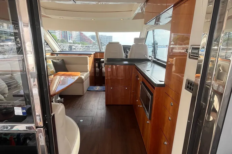  Yacht Photos Pics Luxurious interior of 2015 Riviera 5000 Sport Yacht with sleek wood finishes and modern amenities.