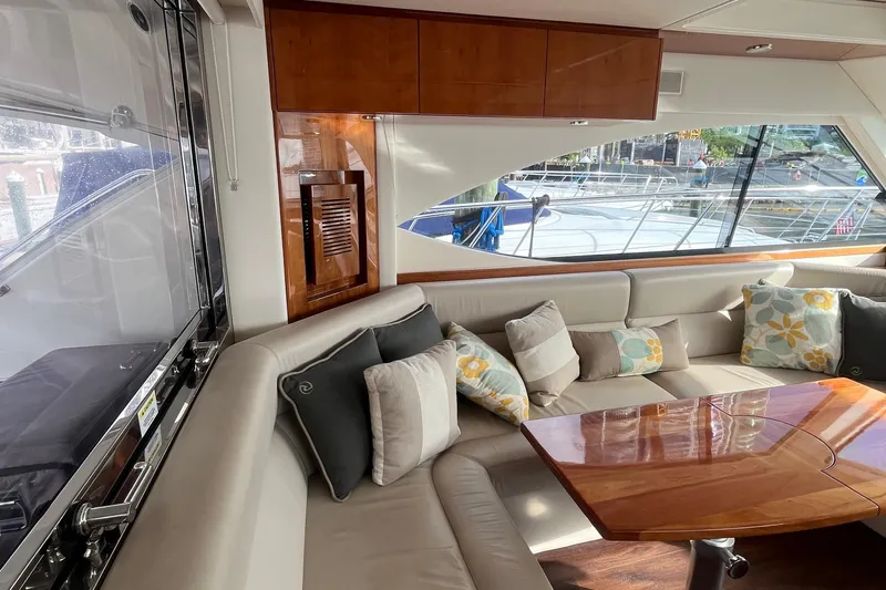  Yacht Photos Pics Luxurious interior of 2015 Riviera 5000 Sport Yacht with plush seating and elegant wood finishes.