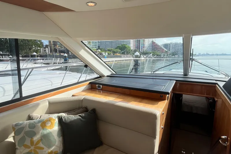  Yacht Photos Pics Interior view of 2015 Riviera 5000 Sport Yacht with waterfront cityscape.