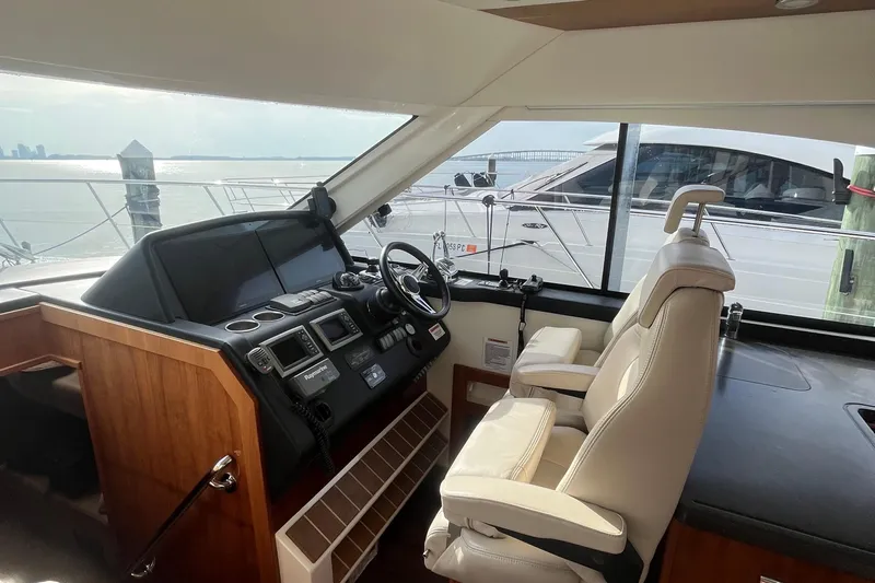  Yacht Photos Pics Interior of 2015 Riviera 5000 Sport Yacht with helm and leather seating.