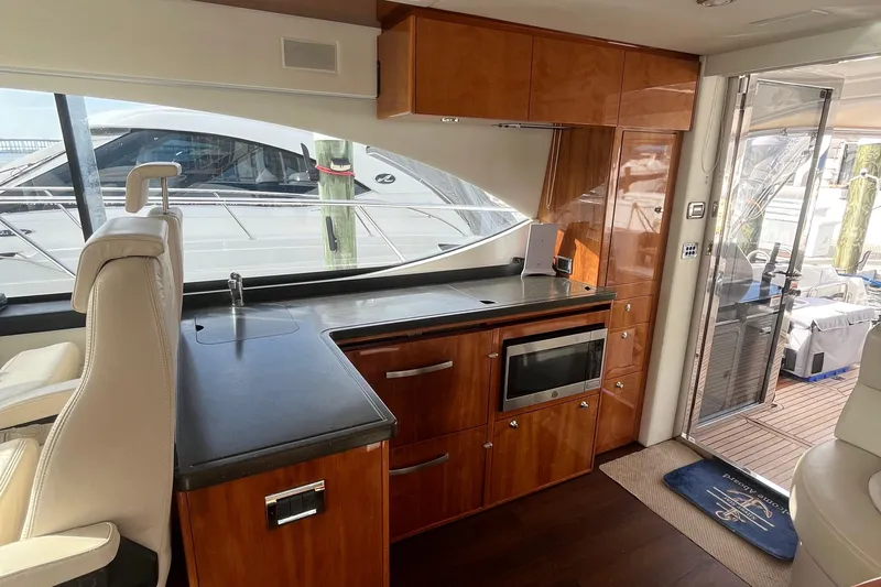  Yacht Photos Pics Luxurious interior of 2015 Riviera 5000 Sport Yacht with modern kitchen amenities.