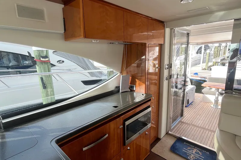  Yacht Photos Pics Interior of 2015 Riviera 5000 Sport Yacht with modern kitchen and outdoor deck view.