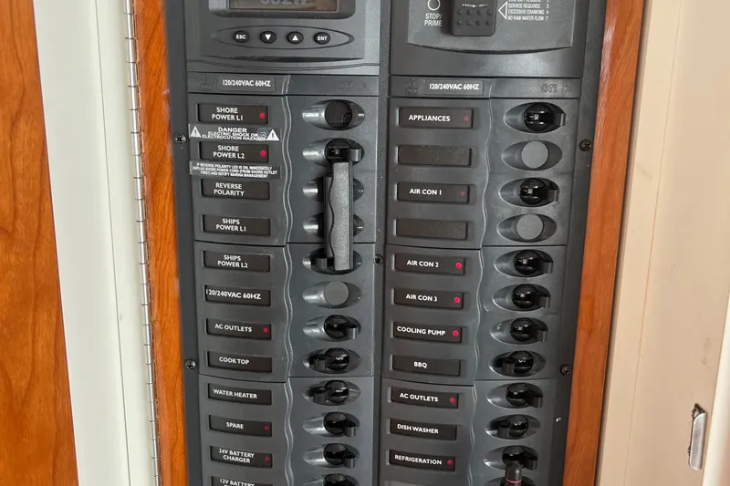  Yacht Photos Pics Electrical control panel on a 2015 Riviera 5000 Sport Yacht, featuring various switches and indicators.