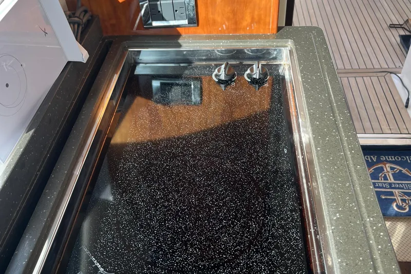  Yacht Photos Pics Stovetop on 2015 Riviera 5000 Sport Yacht with sleek black surface and control knobs.