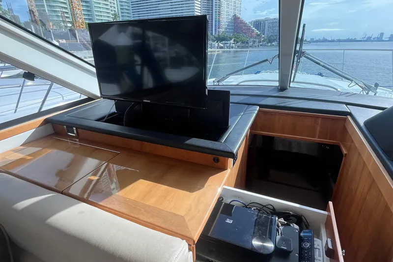  Yacht Photos Pics Interior of 2015 Riviera 5000 Sport Yacht with TV and storage compartment.