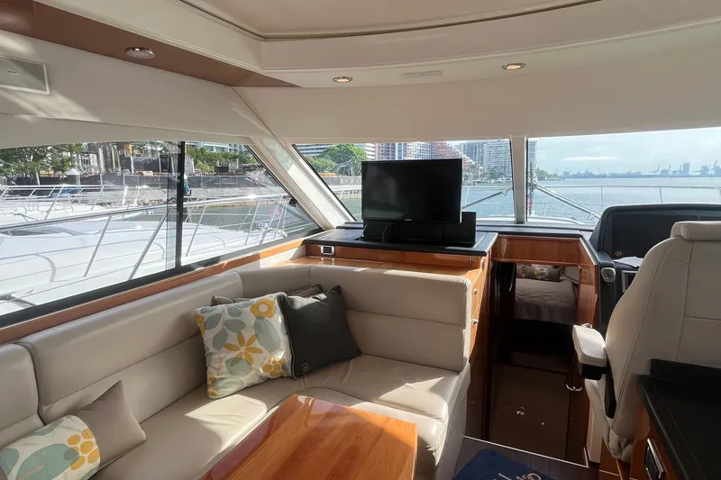  Yacht Photos Pics Luxurious interior of 2015 Riviera 5000 Sport Yacht with plush seating and scenic views.