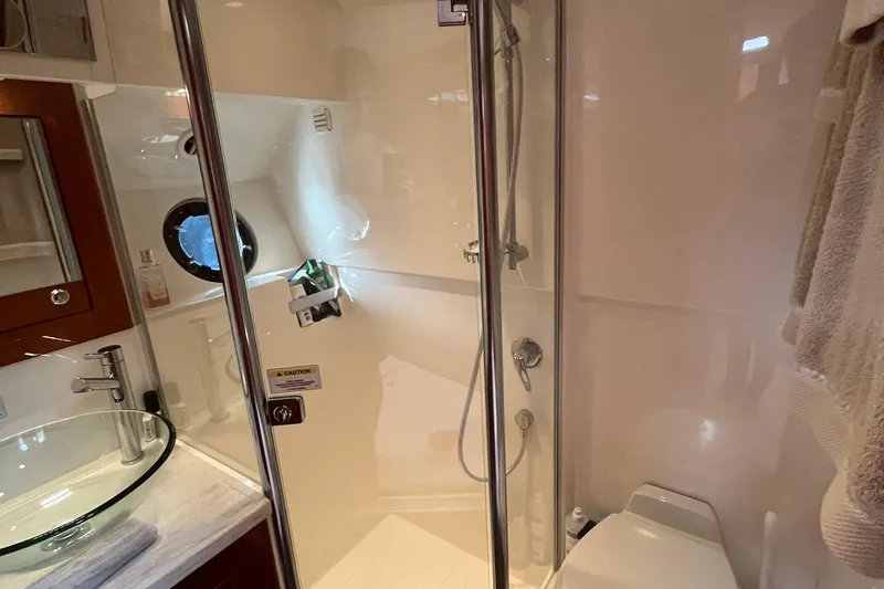  Yacht Photos Pics Bathroom interior of 2015 Riviera 5000 Sport Yacht with glass sink and shower.