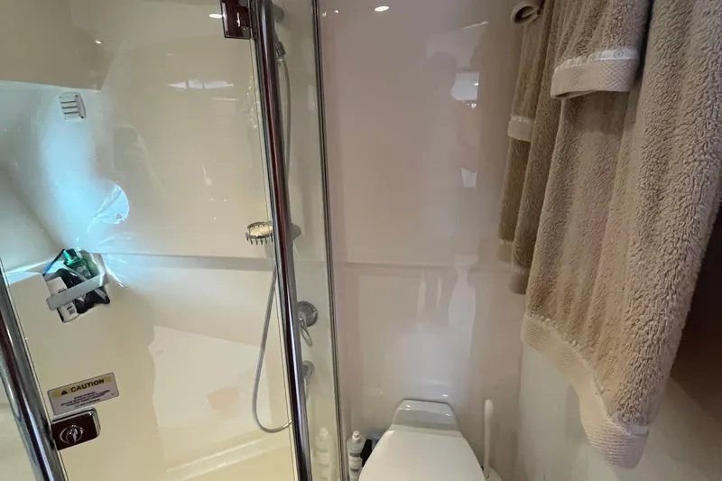  Yacht Photos Pics Bathroom interior of 2015 Riviera 5000 Sport Yacht with shower and towels.