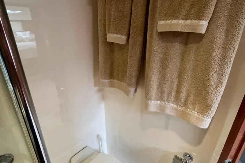  Yacht Photos Pics Bathroom interior of 2015 Riviera 5000 Sport Yacht with beige towels.