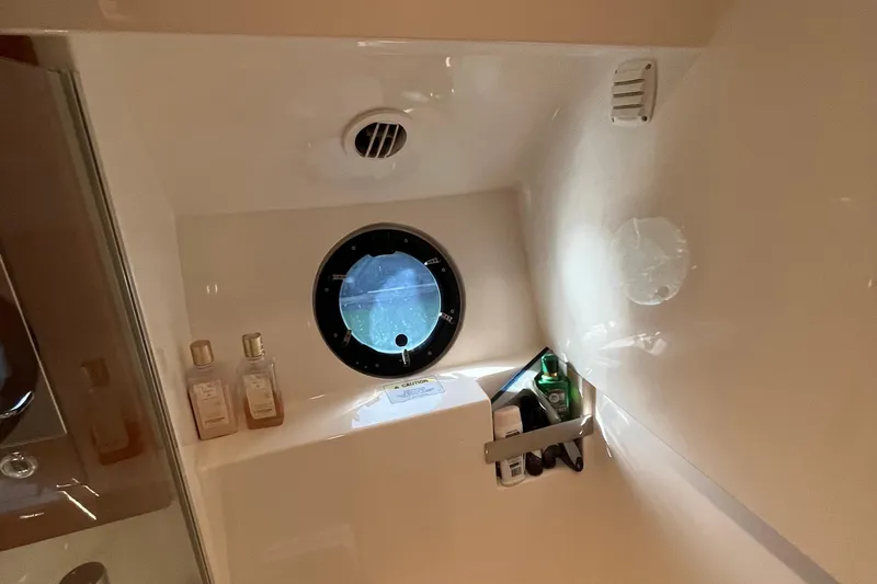  Yacht Photos Pics Interior of 2015 Riviera 5000 Sport Yacht bathroom with porthole and toiletries.