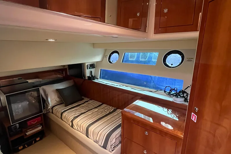  Yacht Photos Pics Luxurious cabin interior of 2015 Riviera 5000 Sport Yacht with wood finish and cozy bed.