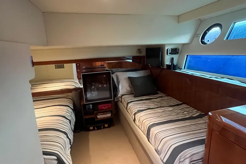 Yacht Photos Pics Interior of 2015 Riviera 5000 Sport Yacht with twin beds and striped bedding.