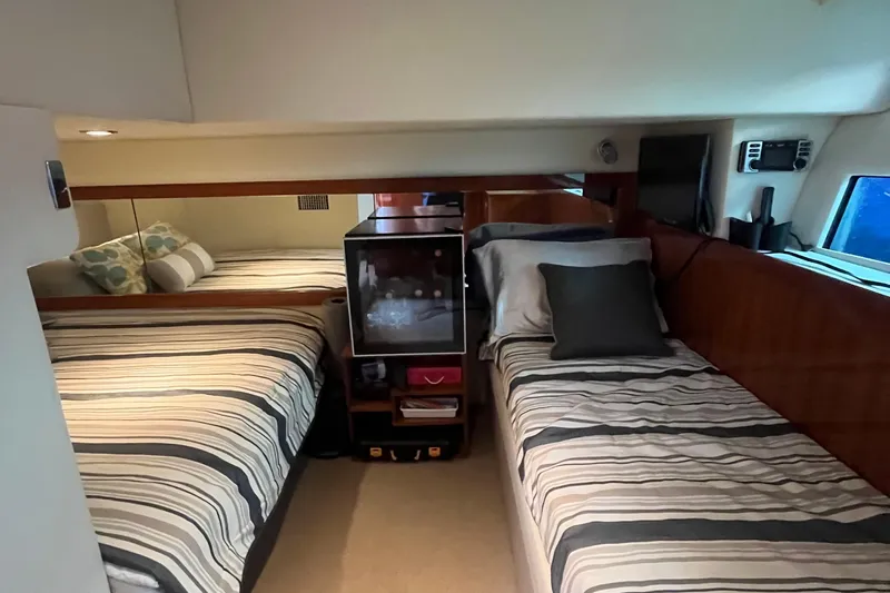  Yacht Photos Pics 2015 Riviera 5000 Sport Yacht cabin with twin beds and striped bedding.