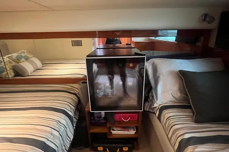  Yacht Photos Pics Interior cabin of 2015 Riviera 5000 Sport Yacht with twin beds and striped bedding.