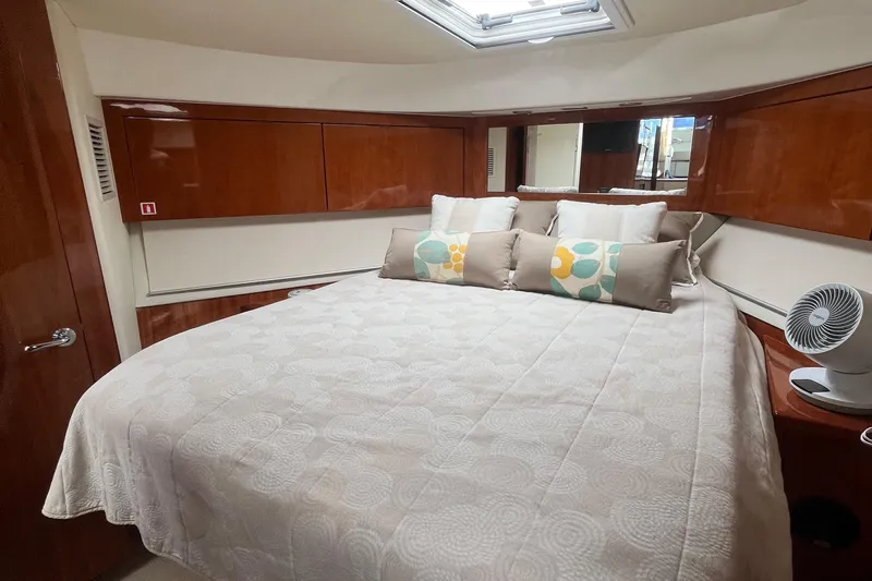  Yacht Photos Pics Luxurious bedroom interior of 2015 Riviera 5000 Sport Yacht with elegant bedding and wood finishes.