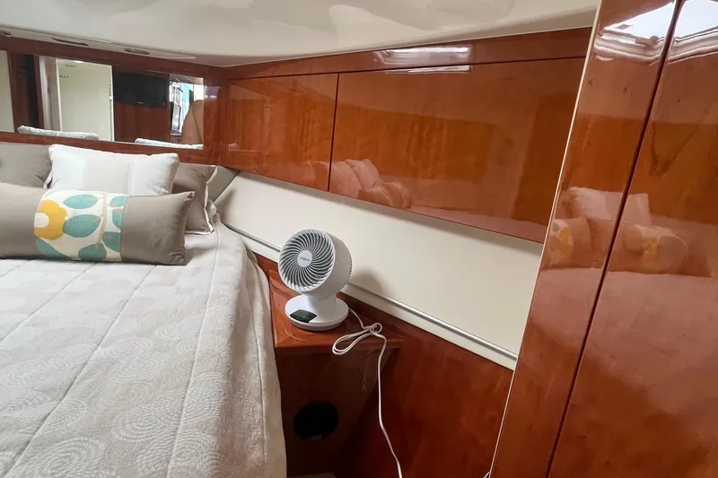  Yacht Photos Pics Luxurious interior of 2015 Riviera 5000 Sport Yacht with elegant wood finish and cozy bedding.