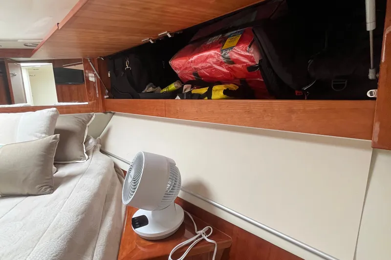  Yacht Photos Pics Interior of 2015 Riviera 5000 Sport Yacht with storage, fan, and bed.