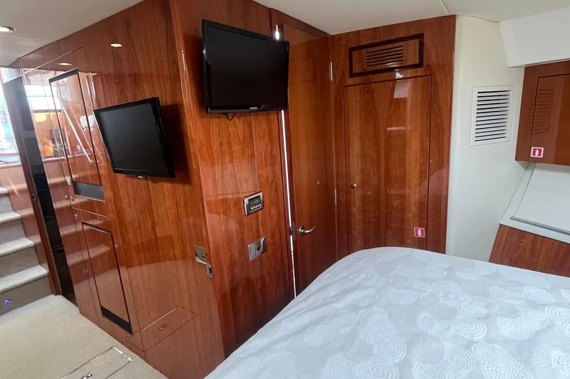  Yacht Photos Pics Interior of 2015 Riviera 5000 Sport Yacht with wood paneling and mounted TV.