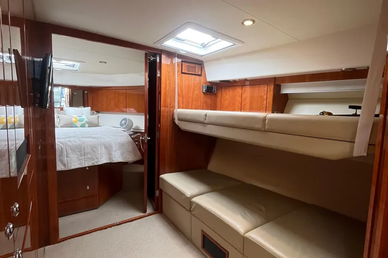  Yacht Photos Pics Interior of 2015 Riviera 5000 Sport Yacht with cozy bedroom and bunk beds.