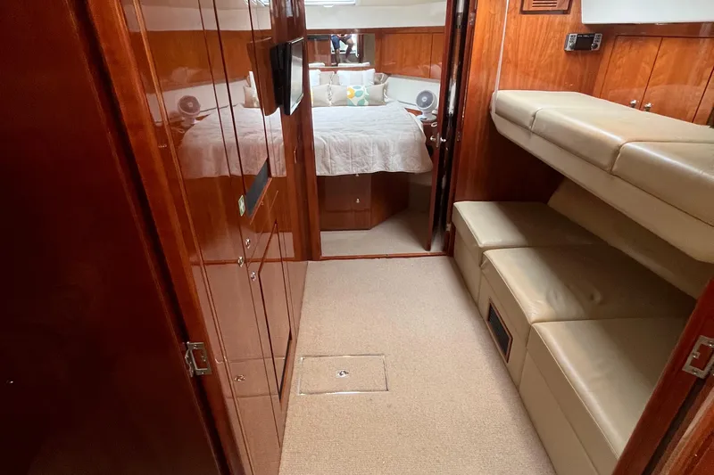  Yacht Photos Pics Interior of 2015 Riviera 5000 Sport Yacht with wood paneling and cozy seating.