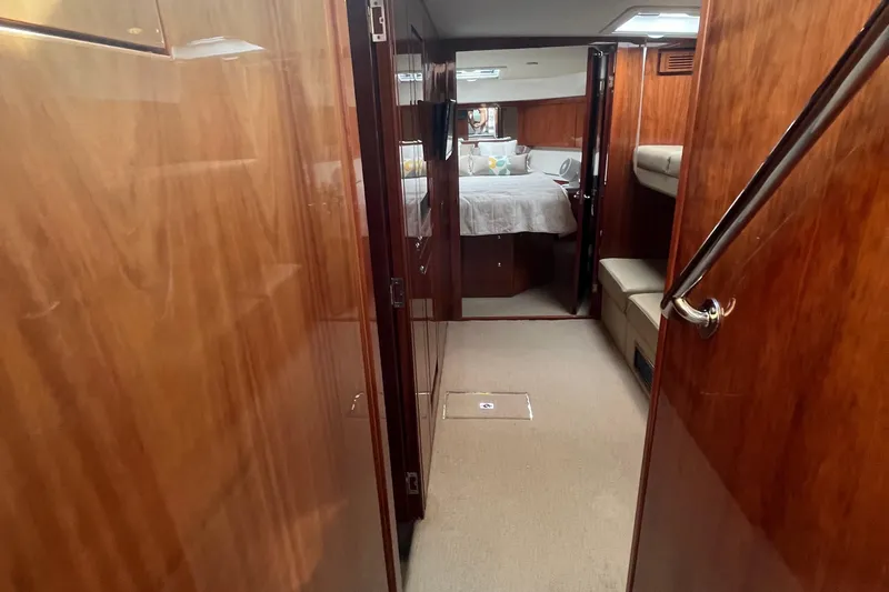  Yacht Photos Pics Luxurious interior of 2015 Riviera 5000 Sport Yacht with polished wood finish.