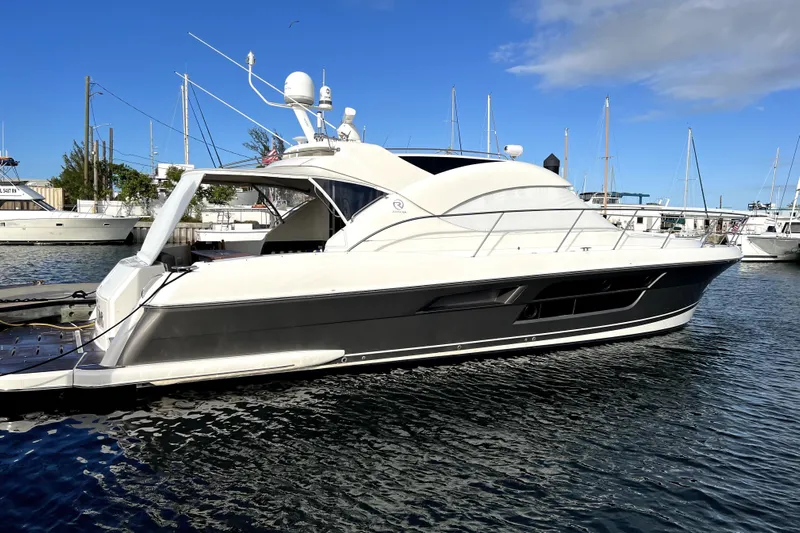  Yacht Photos Pics 2015 Riviera 5000 Sport Yacht docked in a marina under a clear blue sky.