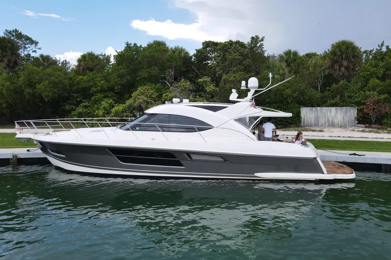  Yacht Photos Pics 2015 Riviera 5000 Sport Yacht docked by lush greenery.