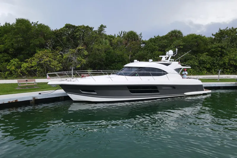  Yacht Photos Pics 2015 Riviera 5000 Sport Yacht docked by lush greenery.