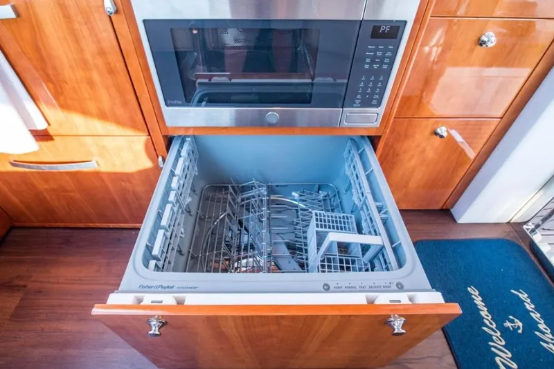  Yacht Photos Pics Modern yacht kitchen with open dishwasher and microwave, Riviera 5000 Sport Yacht, 2015 model.