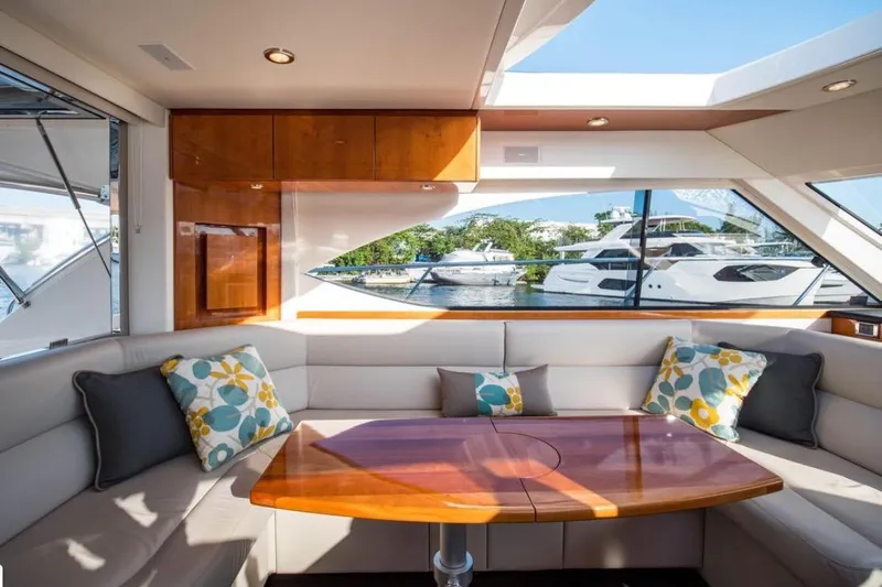  Yacht Photos Pics Luxurious interior of 2015 Riviera 5000 Sport Yacht with elegant seating and scenic window view.
