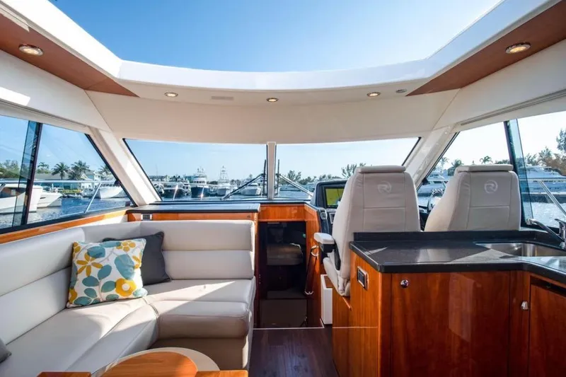  Yacht Photos Pics Luxurious interior of 2015 Riviera 5000 Sport Yacht with plush seating and modern helm.