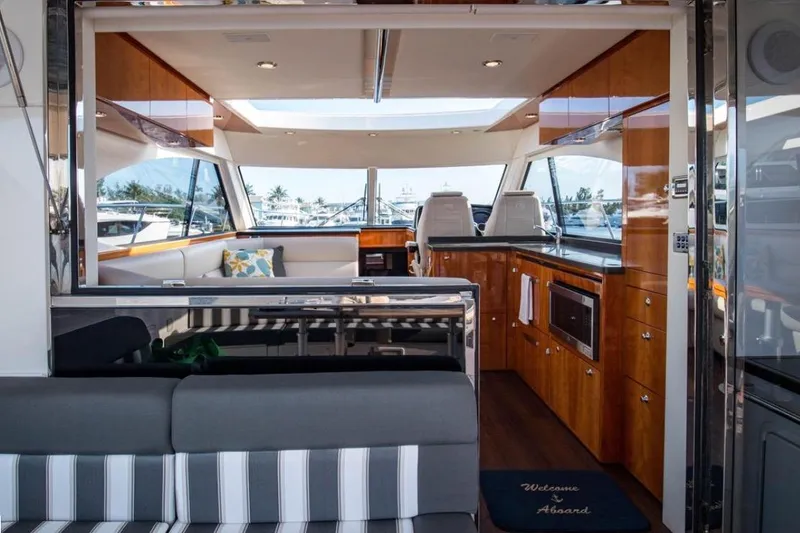  Yacht Photos Pics Luxurious interior of 2015 Riviera 5000 Sport Yacht with modern kitchen and seating area.