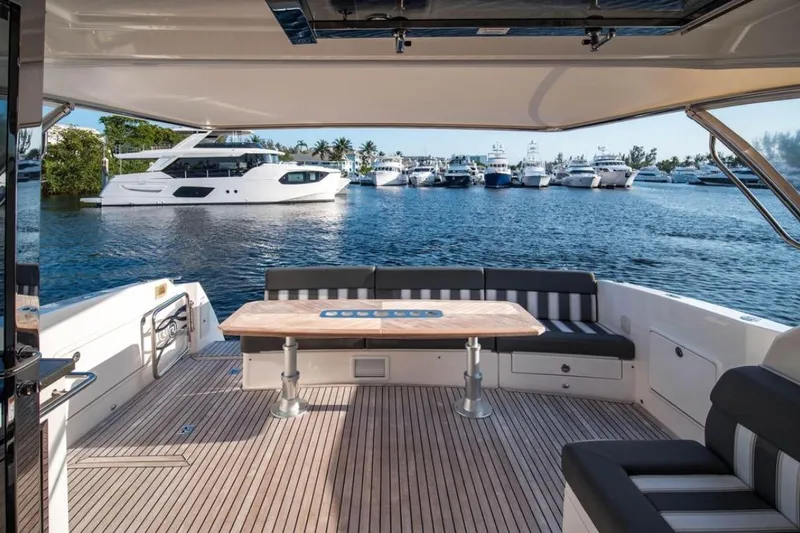  Yacht Photos Pics Luxurious 2015 Riviera 5000 Sport Yacht with spacious deck and scenic marina view.
