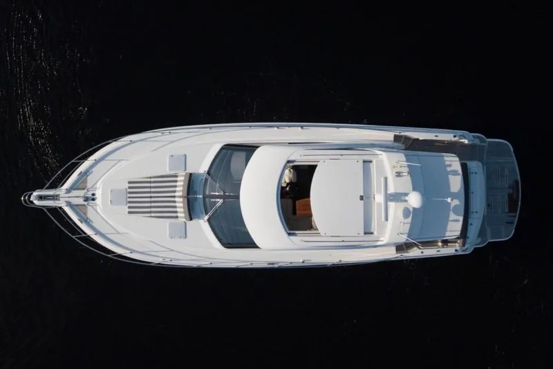  Yacht Photos Pics Aerial view of 2015 Riviera 5000 Sport Yacht on dark water.