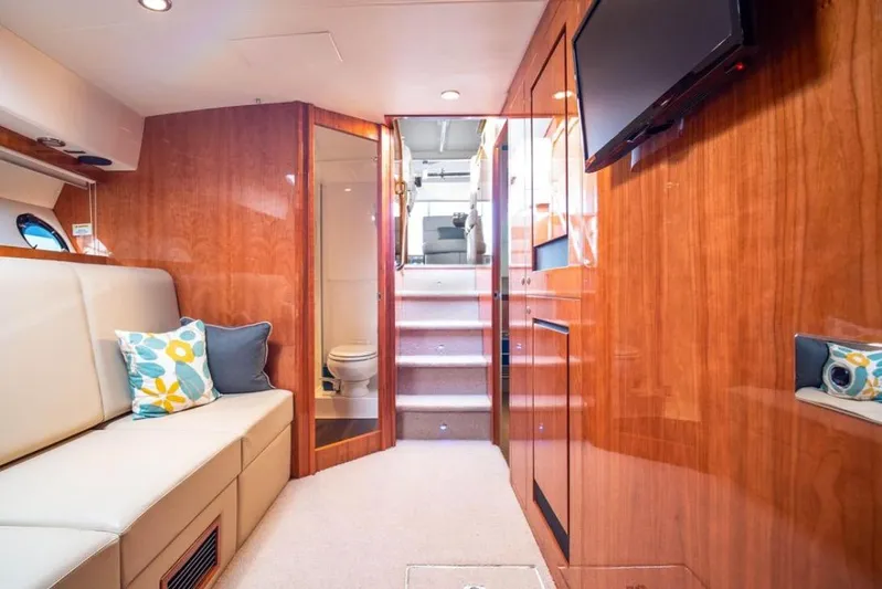  Yacht Photos Pics Luxurious interior of 2015 Riviera 5000 Sport Yacht with wood paneling and modern amenities.