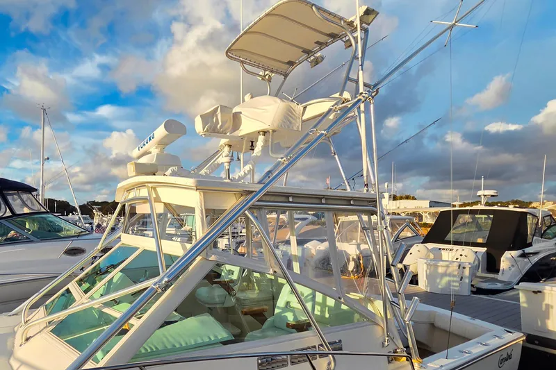 Aggievation Yacht Photos Pics 2007 Carolina Classic 28 Express boat docked under a vibrant sky.