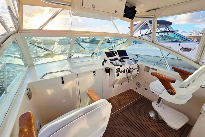Aggievation Yacht Photos Pics 2007 Carolina Classic 28 Express boat cockpit with helm, wooden accents, and marina view.