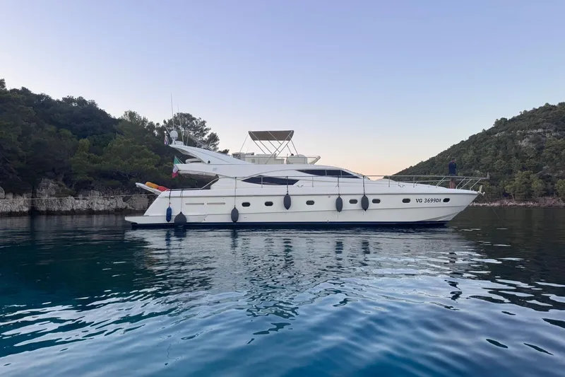  Yacht Photos Pics 2010 Ferretti Yachts 620 on tranquil water, surrounded by lush greenery.