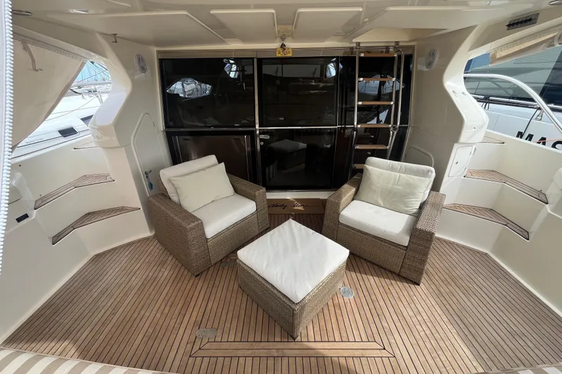  Yacht Photos Pics Luxurious 2010 Ferretti Yachts 620 deck with wicker seating and wooden flooring.