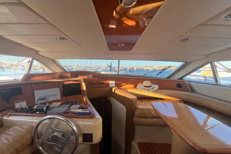  Yacht Photos Pics Luxurious 2010 Ferretti Yachts 620 interior with helm, leather seating, and marina view.