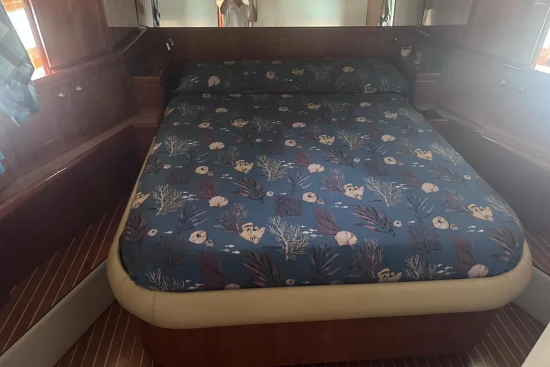  Yacht Photos Pics Luxurious bedroom interior of 2010 Ferretti Yachts 620 with nautical-themed bedding.