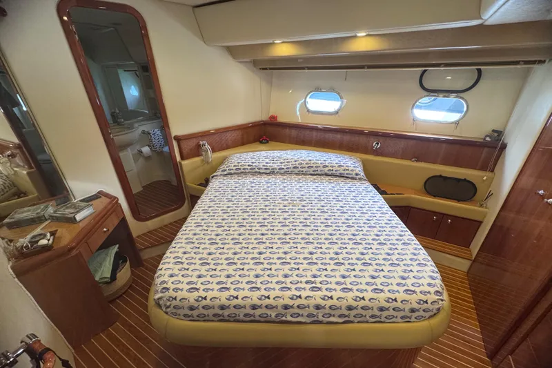  Yacht Photos Pics Luxurious cabin interior of 2010 Ferretti Yachts 620 with elegant bedding and wood accents.