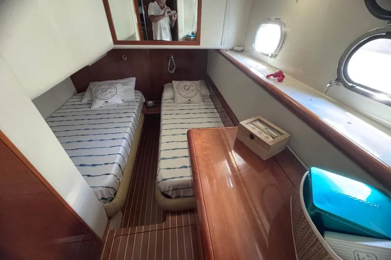  Yacht Photos Pics Cabin interior of 2010 Ferretti Yachts 620 with twin beds and porthole windows.