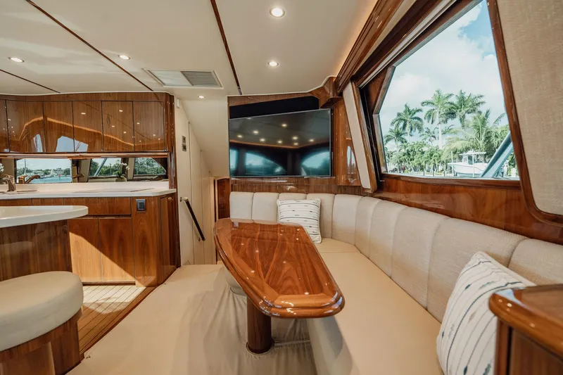 Lori A Yacht Photos Pics Luxurious interior of 2021 Viking 54 Convertible yacht with elegant wood finishes and plush seating.