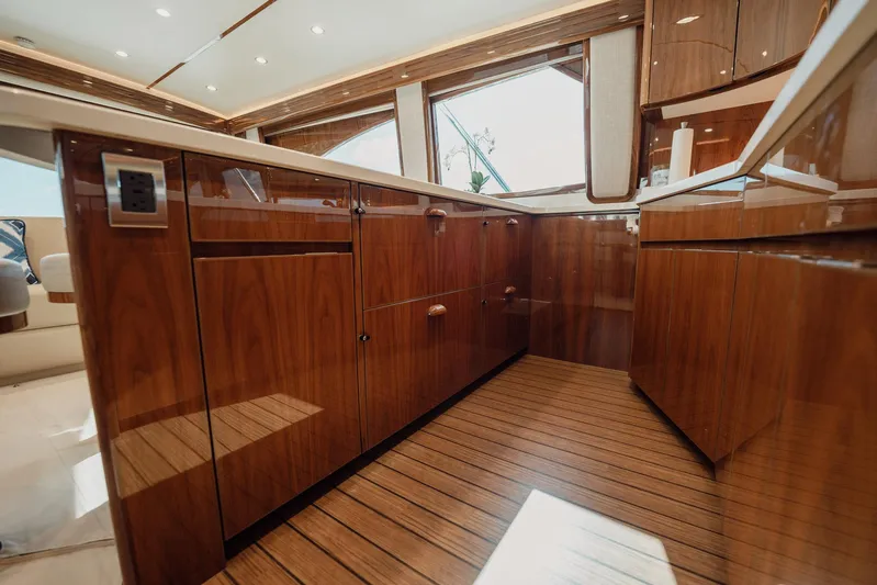 Lori A Yacht Photos Pics Luxurious interior of 2021 Viking 54 Convertible yacht with polished wood cabinetry.