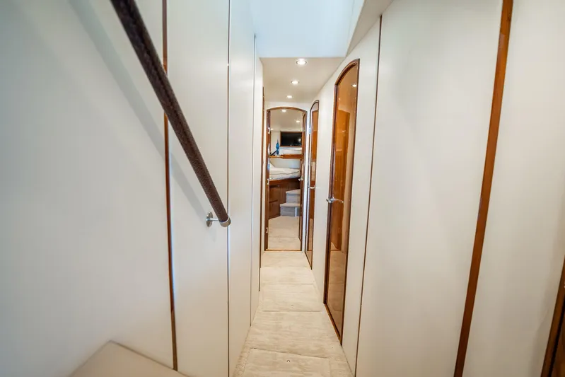 Lori A Yacht Photos Pics Interior hallway of 2021 Viking 54 Convertible yacht, featuring elegant wood accents.