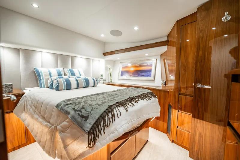 Lori A Yacht Photos Pics Luxurious bedroom interior of 2021 Viking 54 Convertible yacht with elegant wood finish.