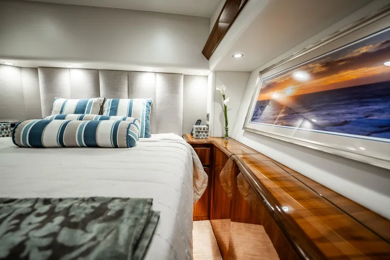 Lori A Yacht Photos Pics Luxurious 2021 Viking 54 Convertible yacht bedroom with elegant decor and ocean view.